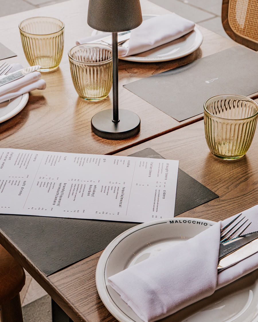 The drinks menu on a laid table at Malocchio